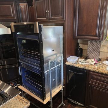 Double wall oven on a lift during built-in oven service